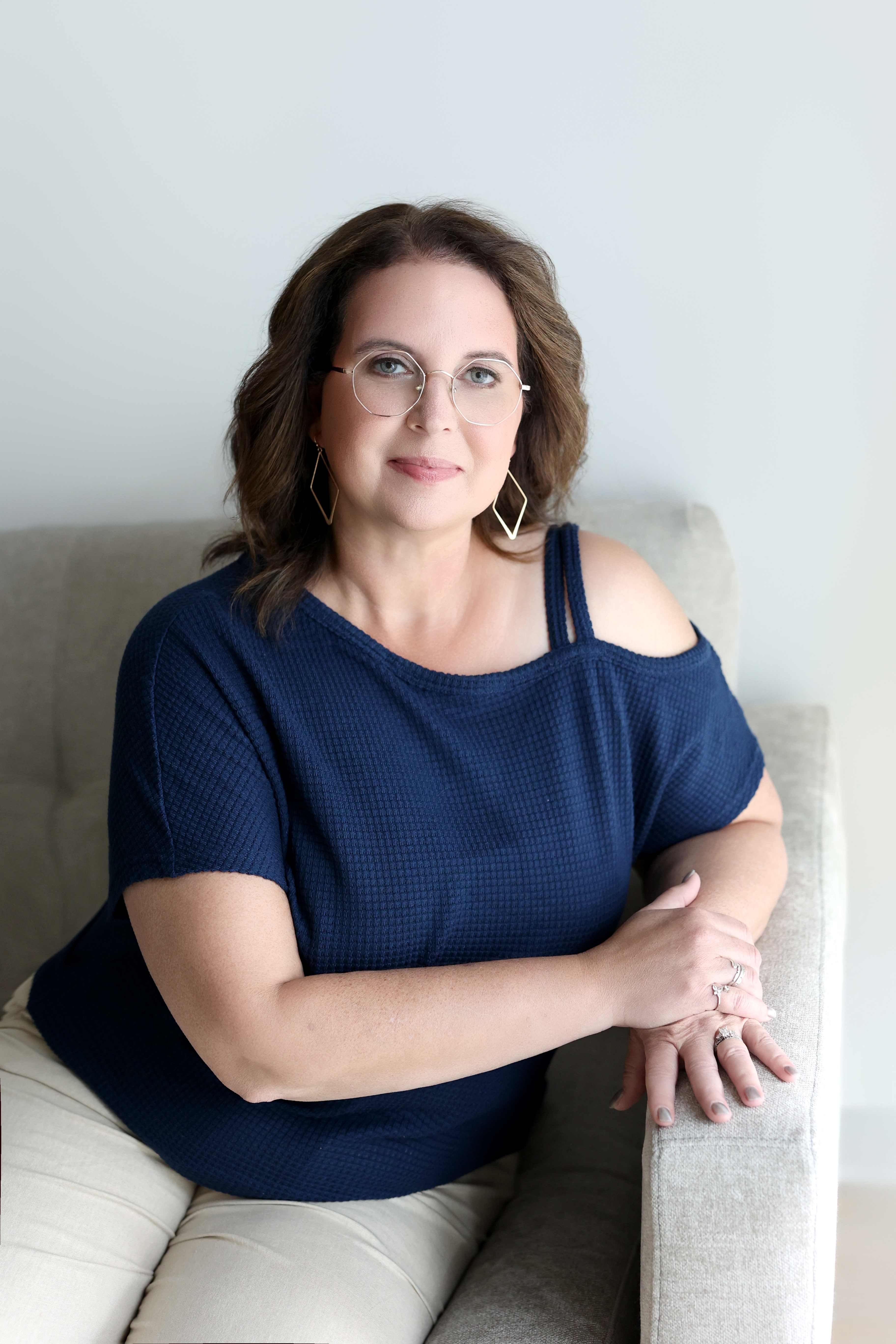 Karen Kay Smith seated in a navy top